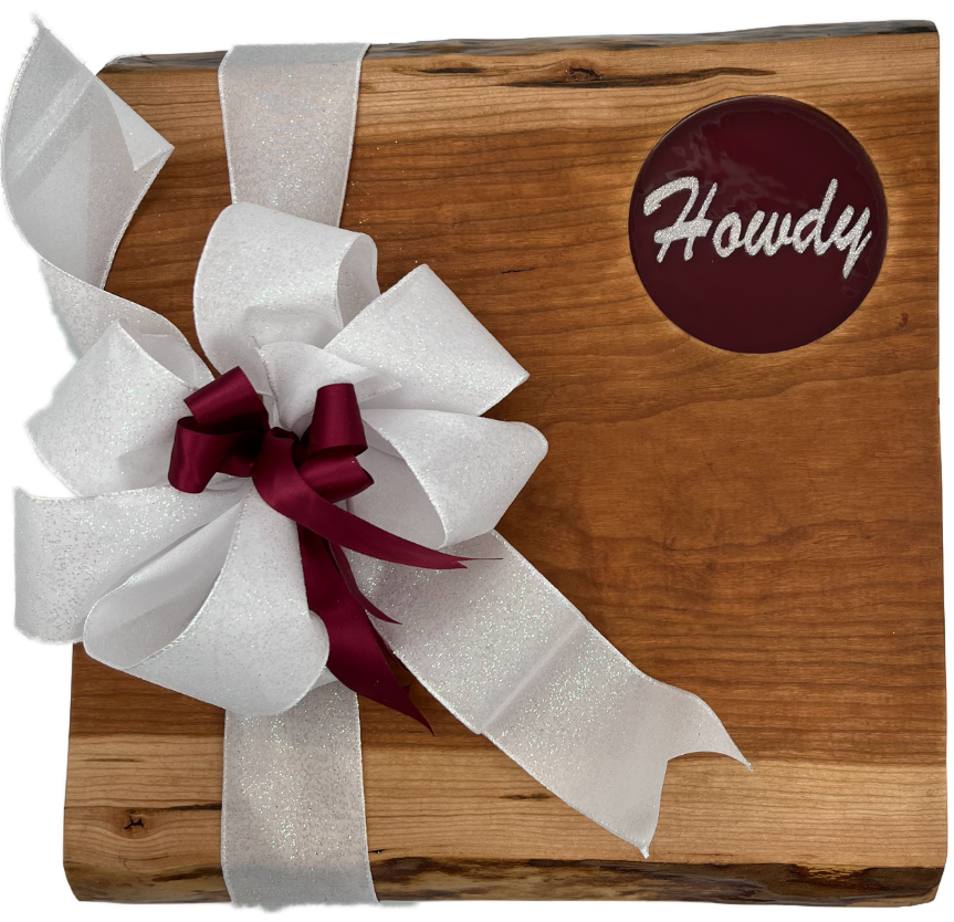 Contemporary Live edge Walnut hard wood board featuring 3D printed text “Howdy”. The artwork is encased in Burgundy food grade resin. Elegant burgundy and White sparkle artwork will define the Howdy friendly atmosphere at any gathering.