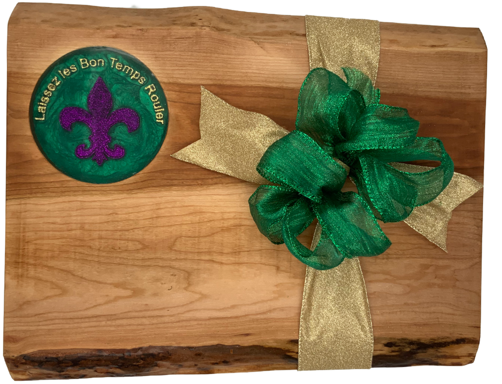 Contemporary Live edge Cherry hard wood board featuring 3D printed text “Laissez les Bon Temps Rouler” encased in food grade resin. Elegant Purple, Green and Gold artwork.